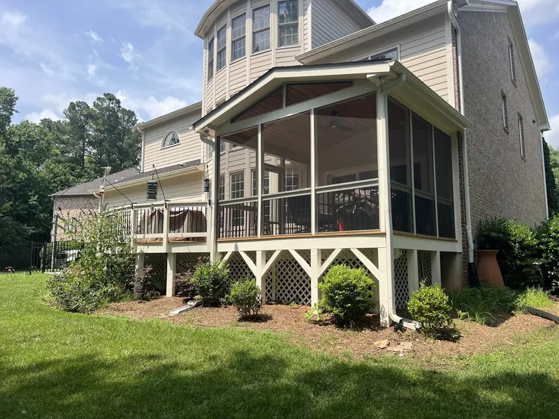 Gable roof screened porch on a raised deck with a lattice skirt, built by Bright Ridge Construction